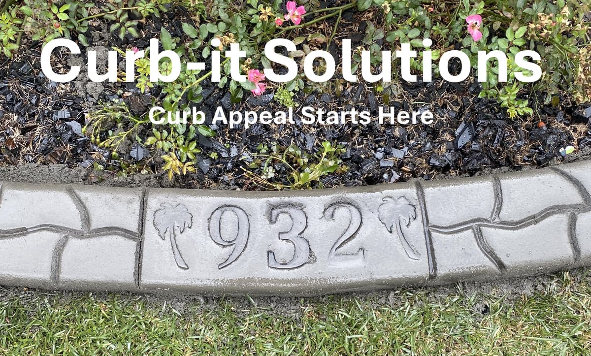 Concrete curbing defining a landscaped bed beside a home
