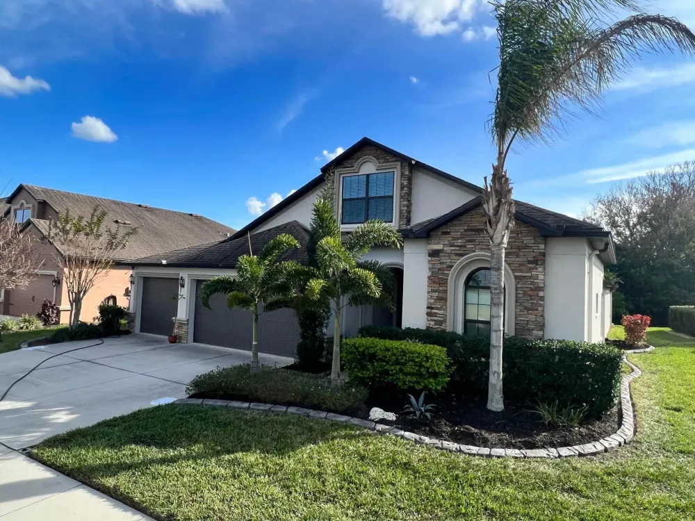 Freshly installed decorative concrete landscape curbing along a flower bed